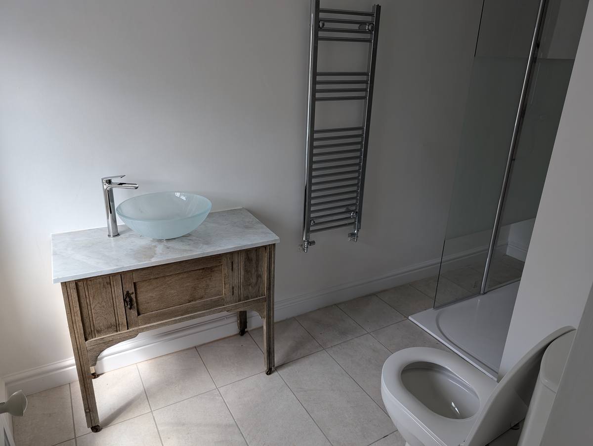 Bathroom suite installation with shower and heated towel rail