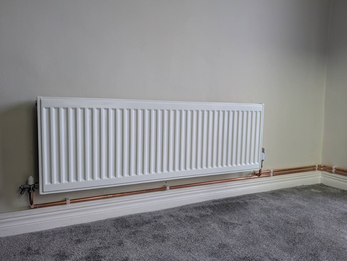 New radiator installation with copper pipework