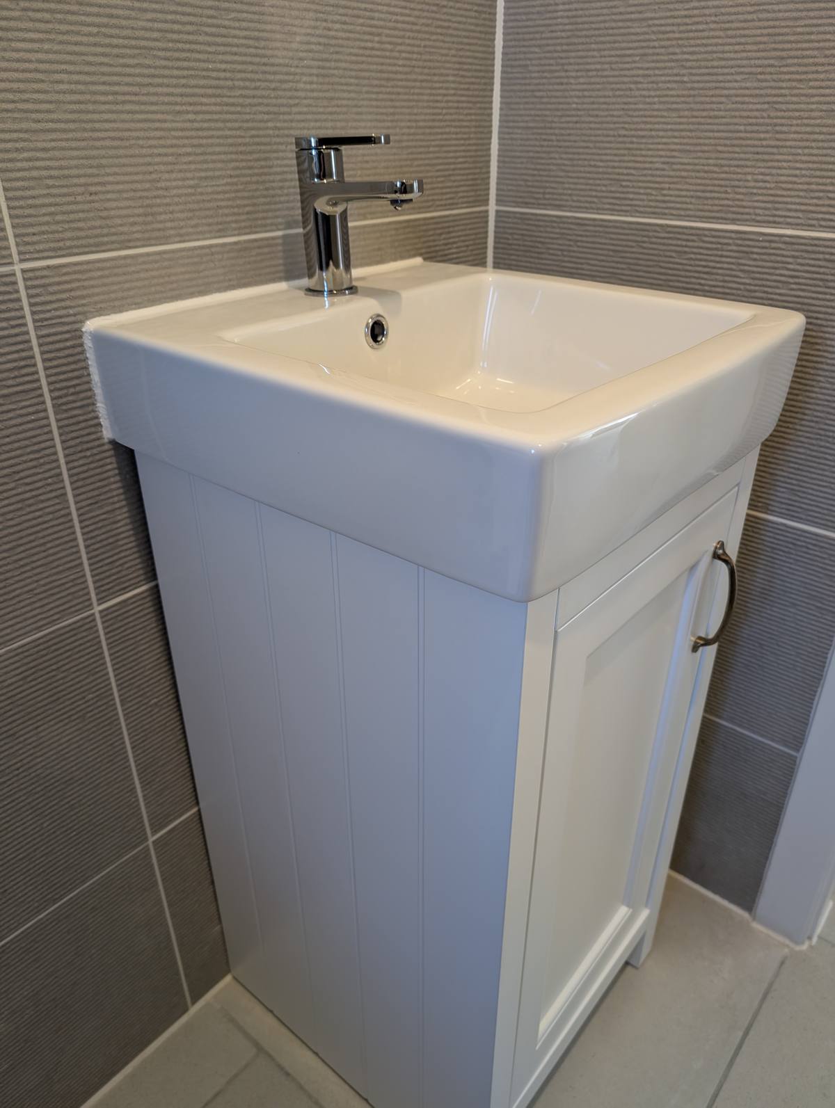 Modern bathroom basin and vanity unit installation